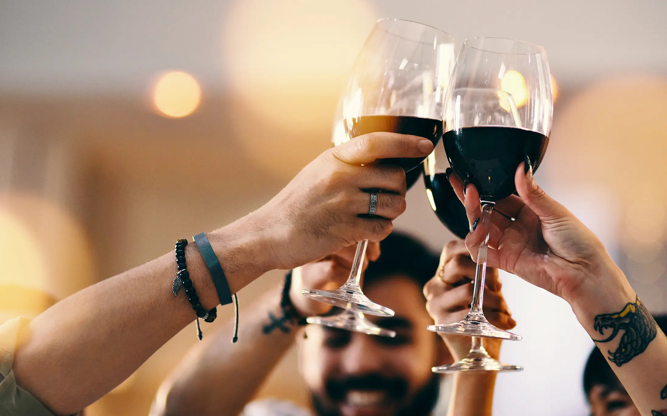 People toasting with wine glasses.