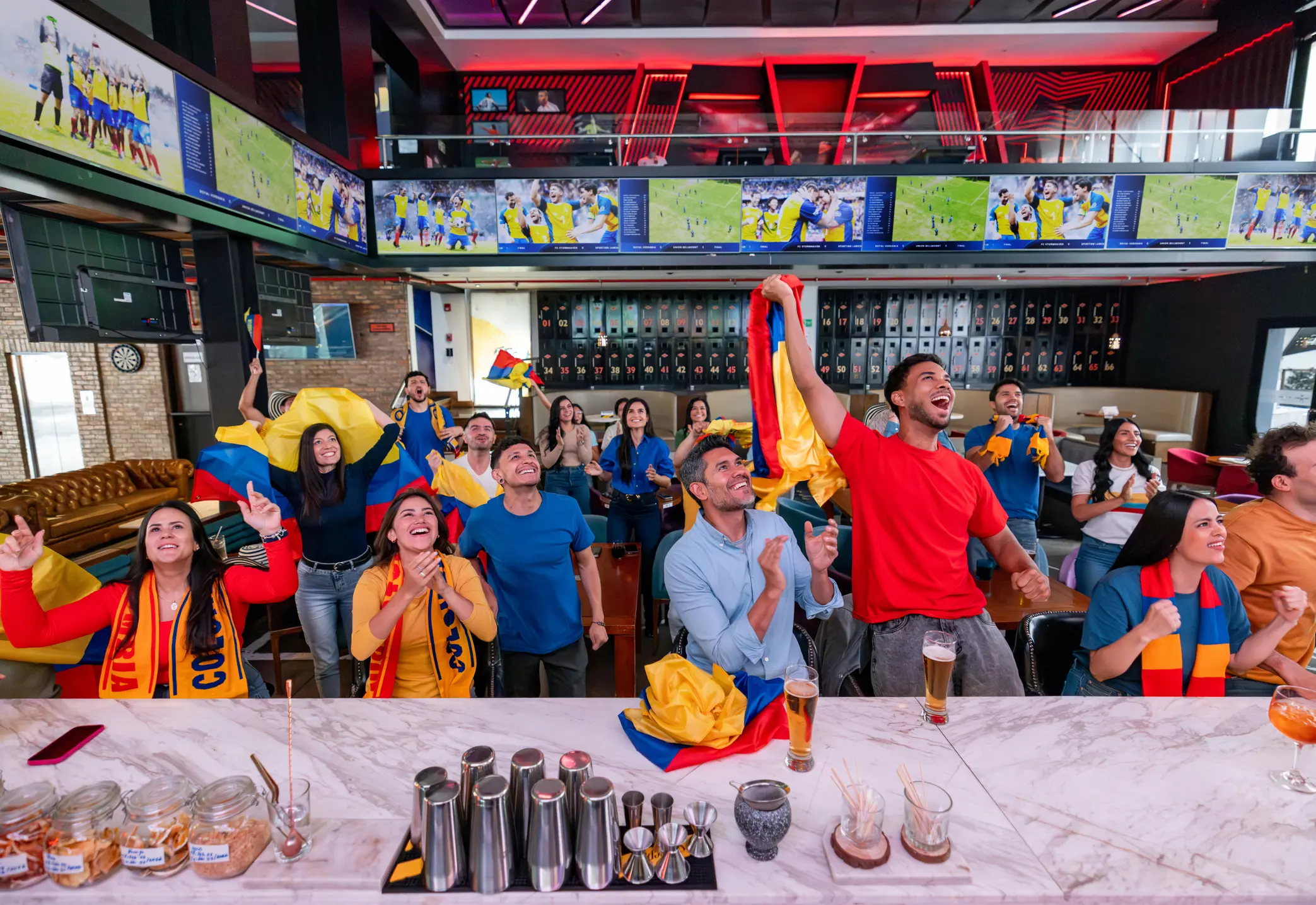 People waving flags and cheering indoors