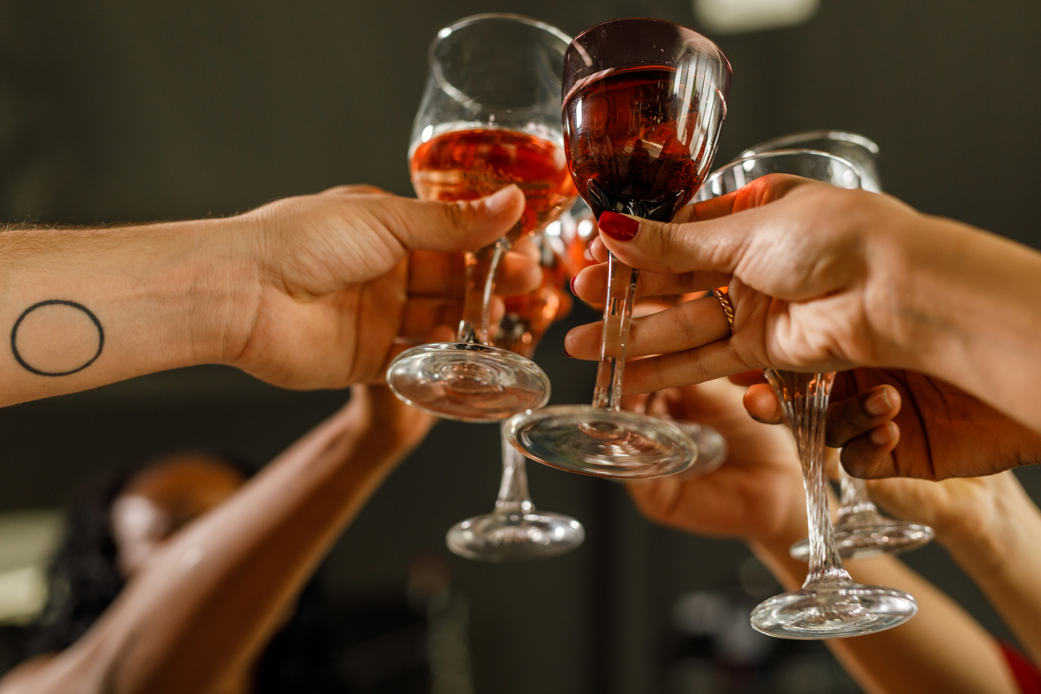People toasting with wine glasses.